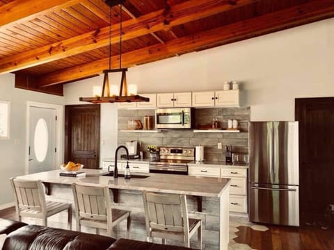 Stainless steel appliances with matching ivory cabinetry adorn the kitchen.