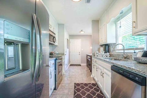 Kitchen with stainless steel appliances. Ice maker with crushed and cubed ice. 