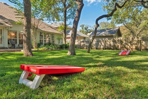 Enjoy backyard fun and games under shady Texas oaks—pet-friendly, fully fenced, and ideal for gatherings in NorthATX.