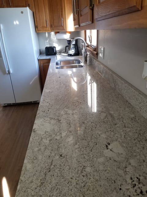 Dishwasher, microwave, coffee pot, and toaster provided.