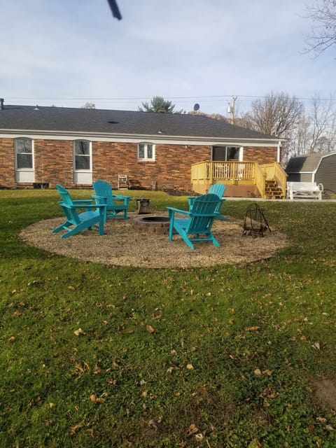 Firepit, back deck, large yard. 4 chairs around firepit.