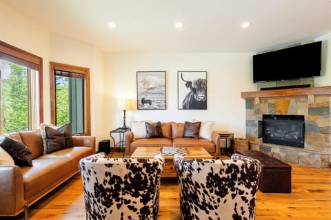 Main Level Great Room with a Gas Fireplace and Hardwood Flooring
