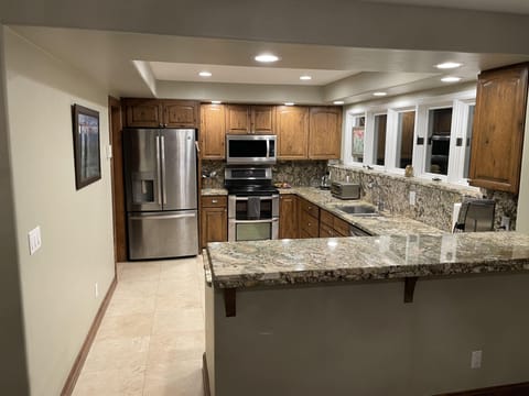 Fully stocked kitchen with grind and brew coffee maker, blender and spices