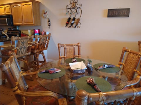 Dining room table and adjoining bar stool seating for 2 more.