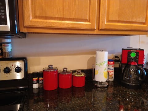 Large 12-cup programmable coffee maker with coffee, filters, sugar, creamer.