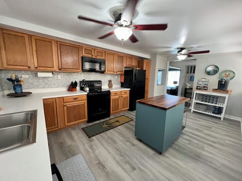 Large kitchen and coffee bar with Keurig, drip and French press coffee makers.