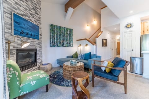 Sink into plush seating by your cozy fireplace, where artful decor and warm lighting create the perfect retreat for evening relaxation.