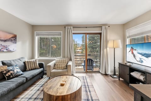 Living Room: 55" Smart TV, comfortable seating, patio access