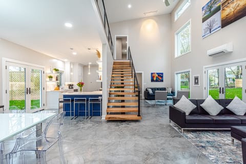 dining and kitchen, floating stairs, great room w/ 24' ceiling, balcony