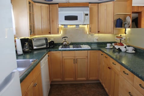 A full size fridge, dish washer, and counter top appliances.