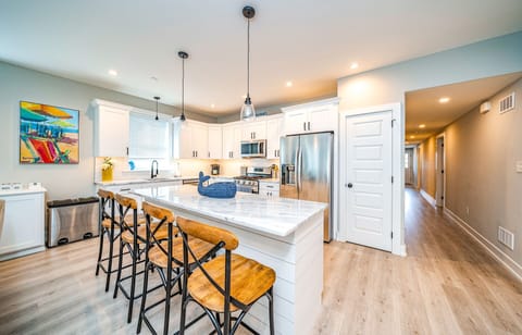Open concept modern kitchen with island seating for 4.