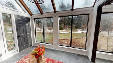 Sunroom with small freestanding fireplace