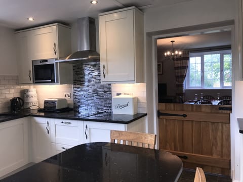 The Kitchen has a convenient half solid Oak door into the Dining Room