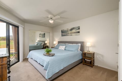 Bright bedroom has a king sized bed.