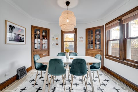 Gather around your elegant dining table beneath a stunning wicker pendant light, where meals become memories.