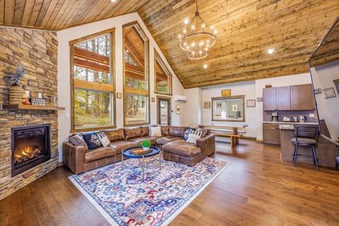 High Ceiling Great room with Floor to Ceiling Stone Indoor Gas Fireplace