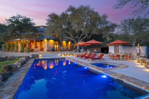 Pool at twilight with pool lights on.