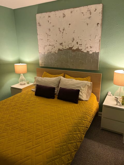 A Bohemian treat with bold colors and IKEA bed and nightstands.