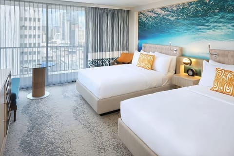 Wake up to bright city views and airy, modern comfort.