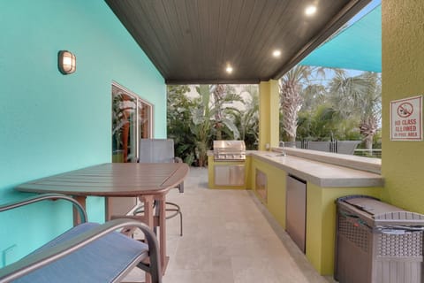 Fully equipped outdoor kitchen with commercial grill, sink, and mini fridge