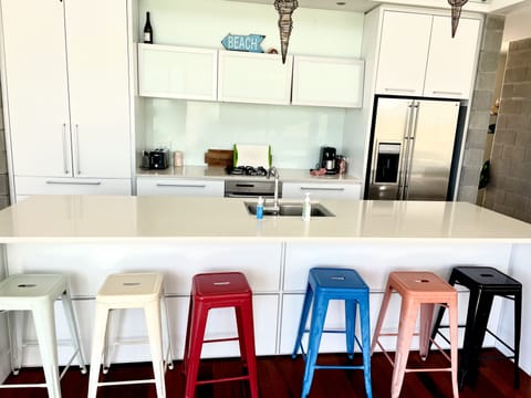 Large modern kitchen with island brunch bar.