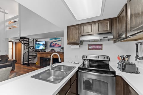 Full size kitchen with stainless steel appliances.