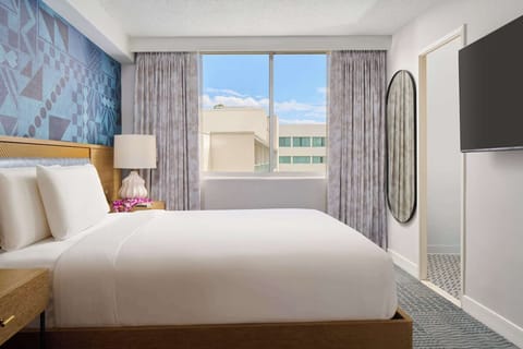 Stretch out on a plush king bed beneath calming decor.