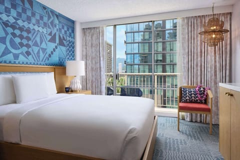 Unwind in crisp linens with bright city views outside.
