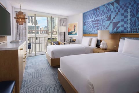 Unwind in bright twin beds with breezy balcony views.