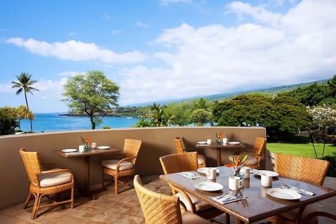 Linger over open-air breakfast with sweeping coastline views.
