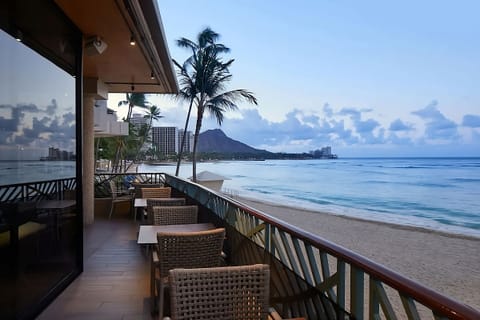 Linger over lunch with panoramic beach and blue-water views.
