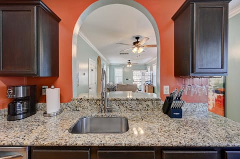 Kitchen overlooks dining area and living room.