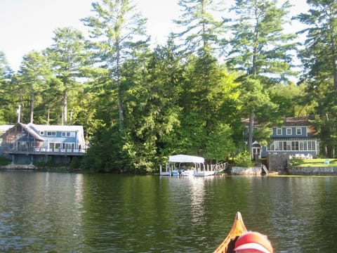 View of both houses from the lake with a dock in between. Little House on left.