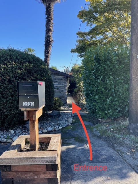 The sidewalk on the right side of the house to the Airbnb.
