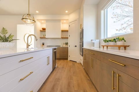 This view of the kitchen shows the pantry, the large island and the generous prep area.