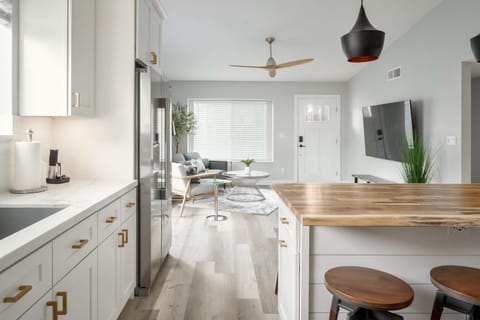 The stylish kitchen opens directly to the living room/front door. Great for game day or entertaining.