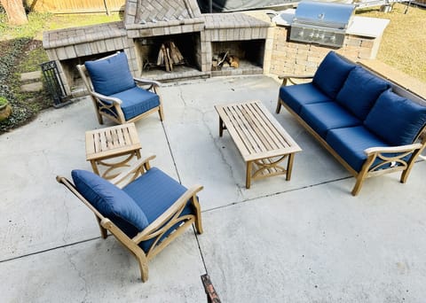 Outdoor Fireplace with a great seating area and Chef's propane grill