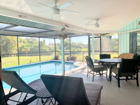 Relaxing lanai with pool and view of the canal.