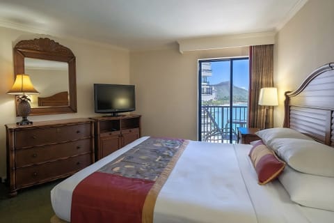 Unwind in a calm king room with ocean-breeze balcony.