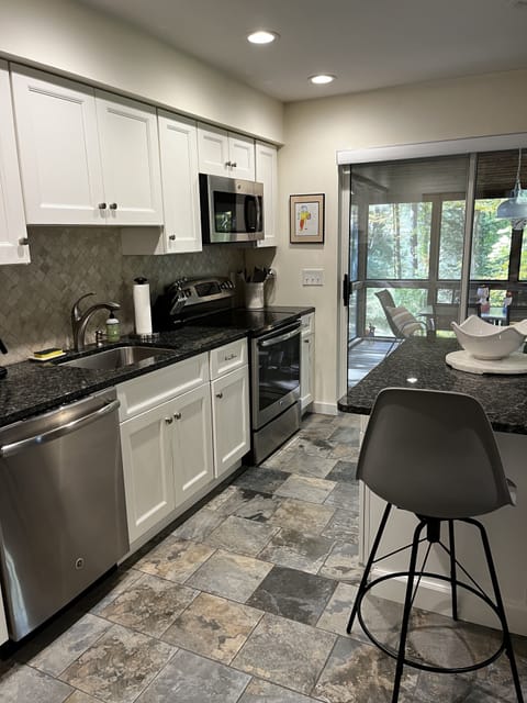 Kitchen leads out to screened in porch