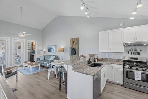 Spacious living room, dining area, kitchen with ample seating.