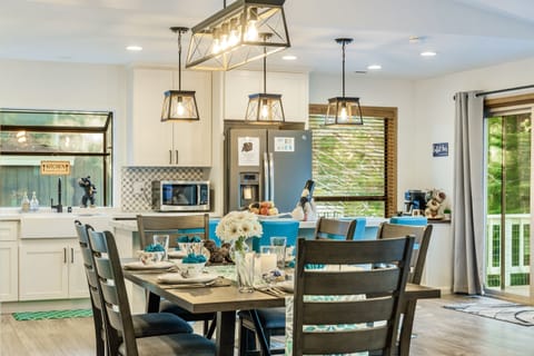 Dining table looking into renovated kitchen with box bay window