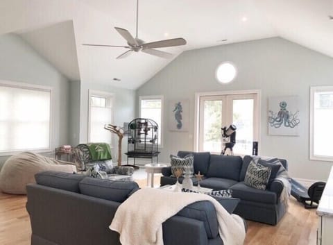 2nd floor family room with 2 sofas and recliner chair.  