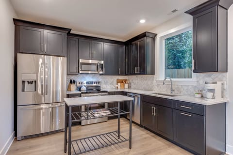 Kitchen is well appointed with cookware, utensils, bakeware, & small appliances