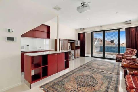 Downstairs family room with smart Television, mini fridge, games and books.