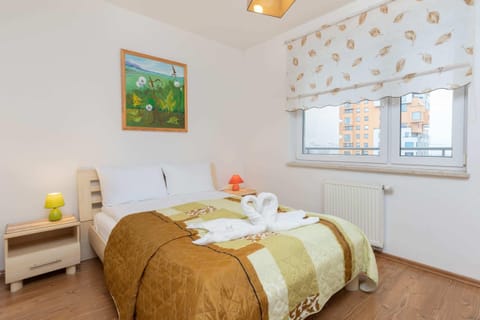 A cozy bedroom with a large bed, soft lighting, and colorful decor for a relaxing stay.