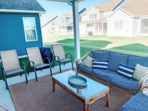 Covered patio with sofa, loveseat, plenty of seating.