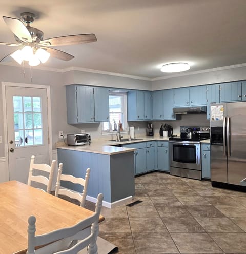 Kitchen with cookware, dishes and utensils.