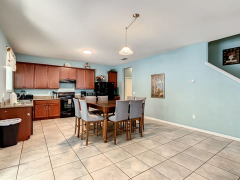 kitchen area and bar table with 8 bar chairs