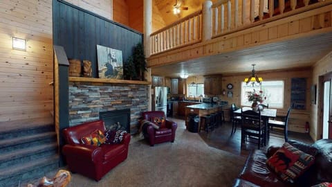 Open living room with seating and a fireplace.